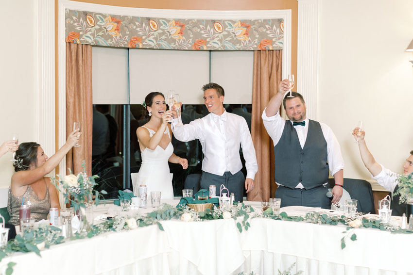 Bride and Groom Cheers at Wedding Reception